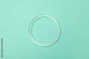 A contraceptive ring on a green background in a blog post about 10 GUARANTEED CONTRACEPTION METHODS FOR YOU IN 2023.