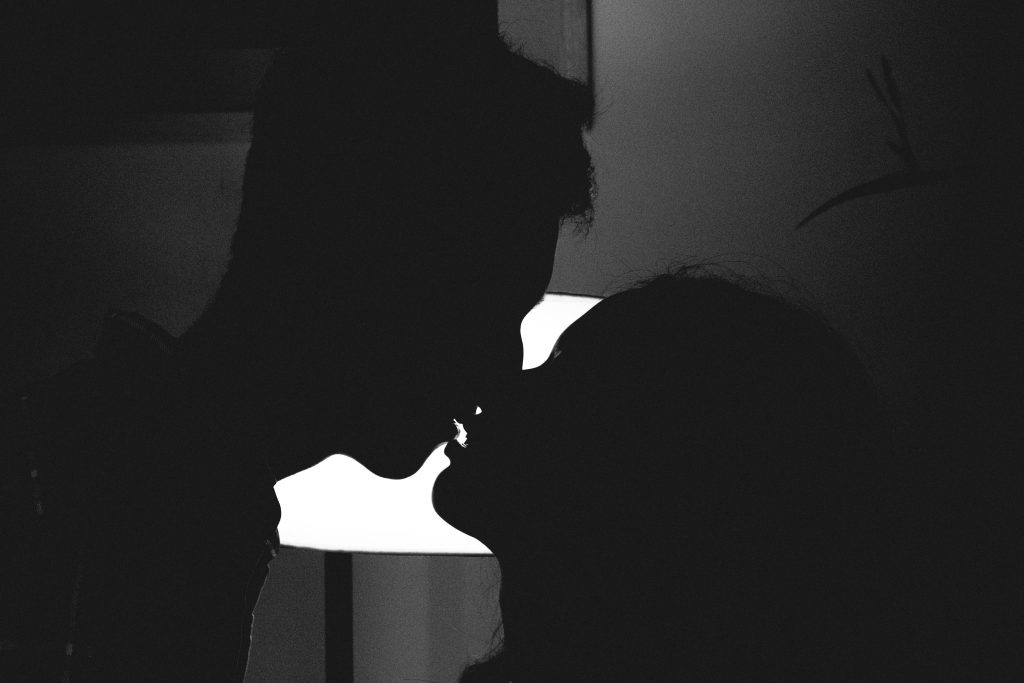 An silhouette image of two figures kissing in a blog post on how to deal with intimacy.